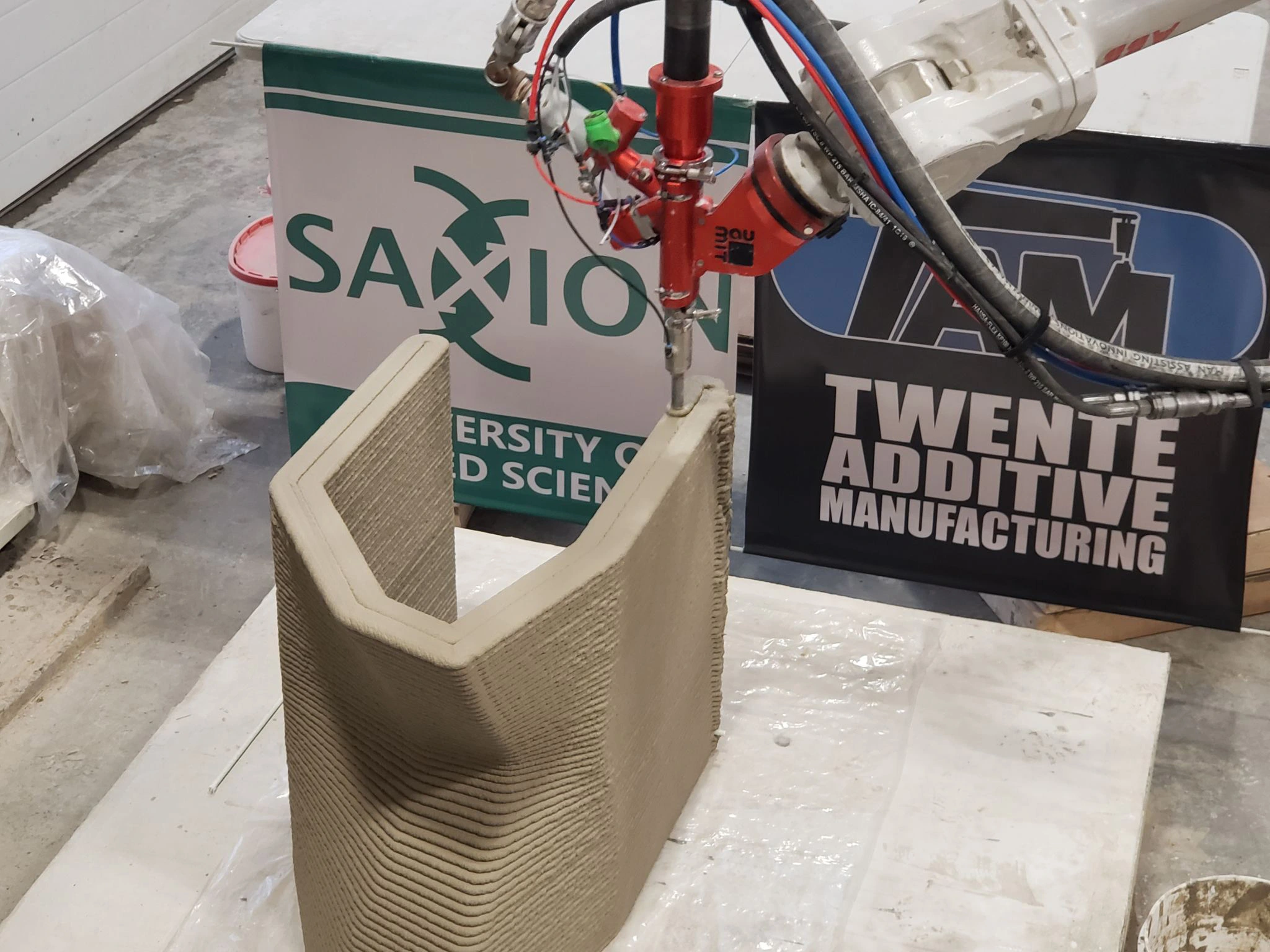 Close view of the layered concrete fish-ladder component during robotic printing