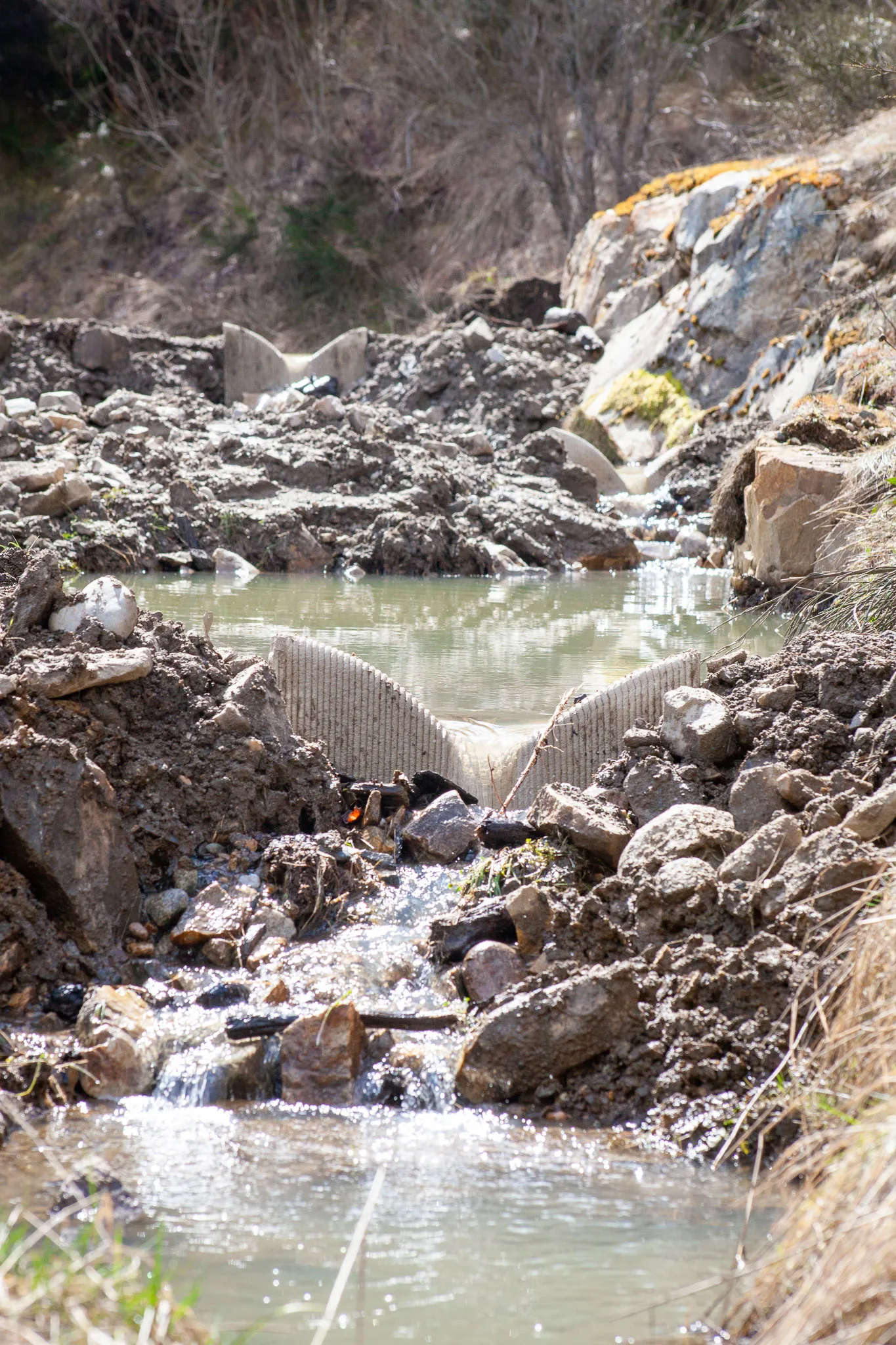 Concrete fish-ladder steps directing water down a rocky Canadian stream