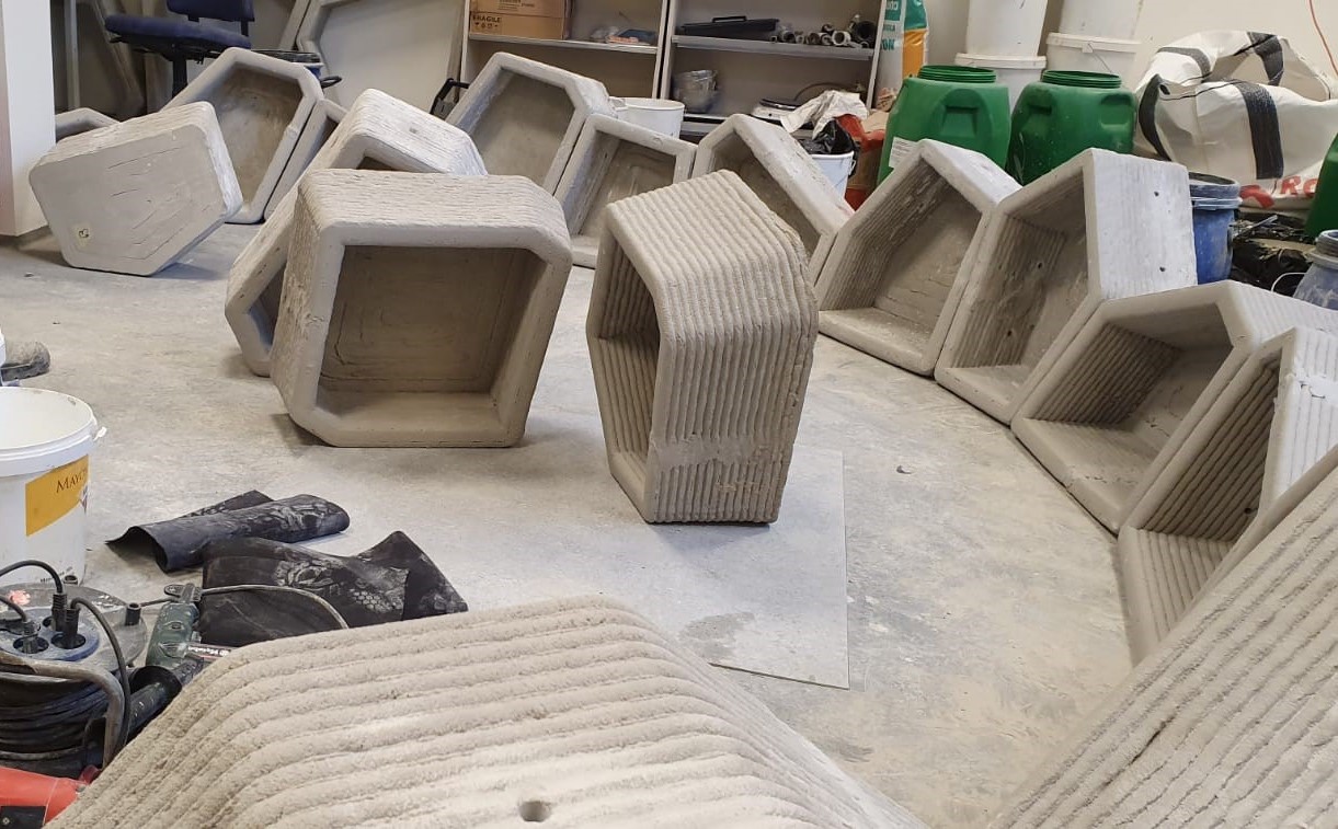 Completed concrete blocks arranged on the workshop floor