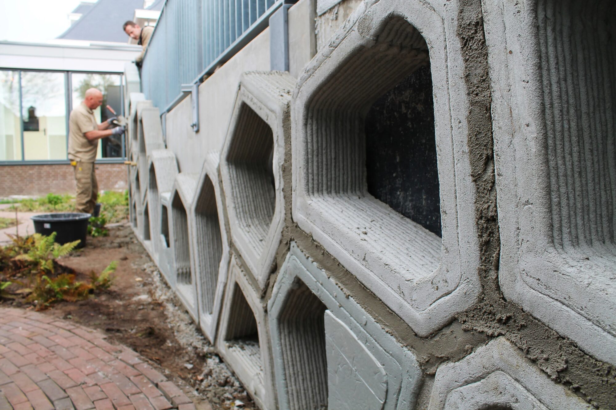 Close view of assembled 3D-printed concrete facade elements