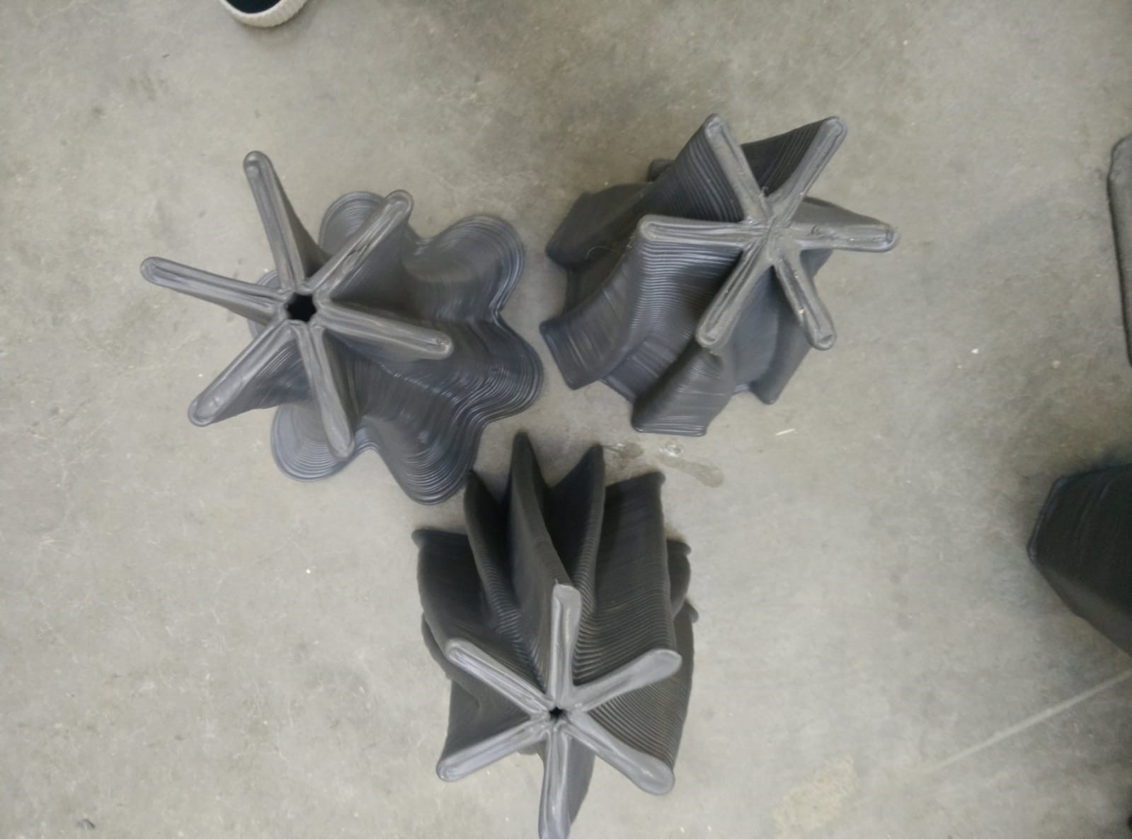 Three vases turned upside down to show their enclosed, radial base profiles