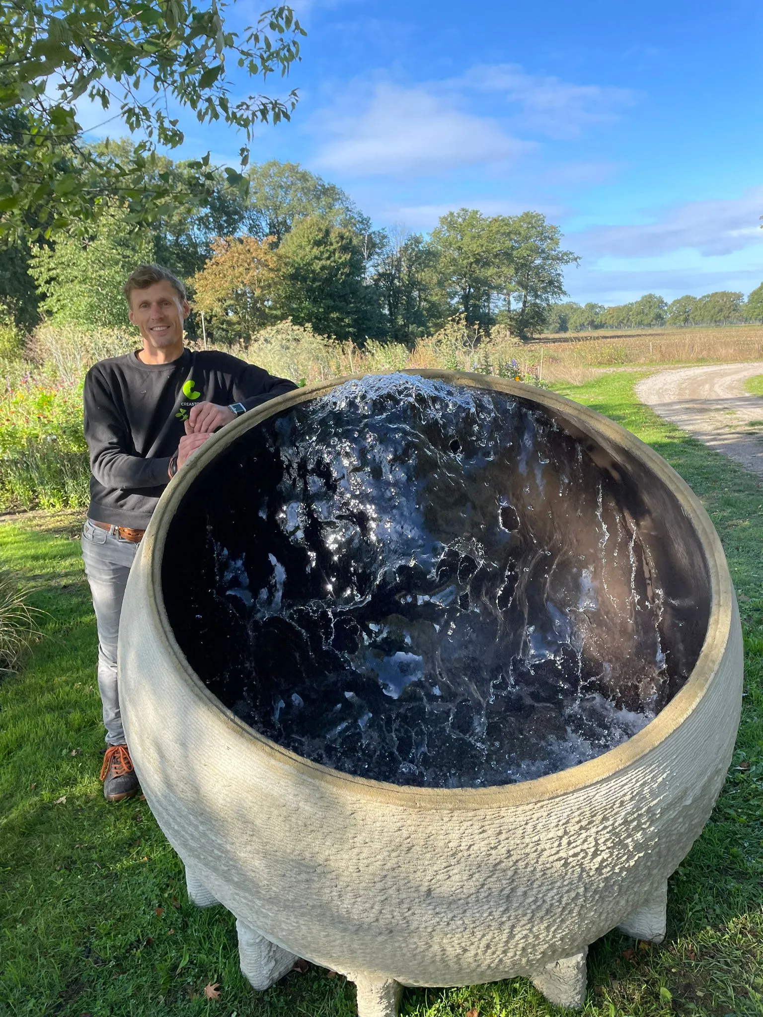 Large finished spherical water feature with a reflective interior