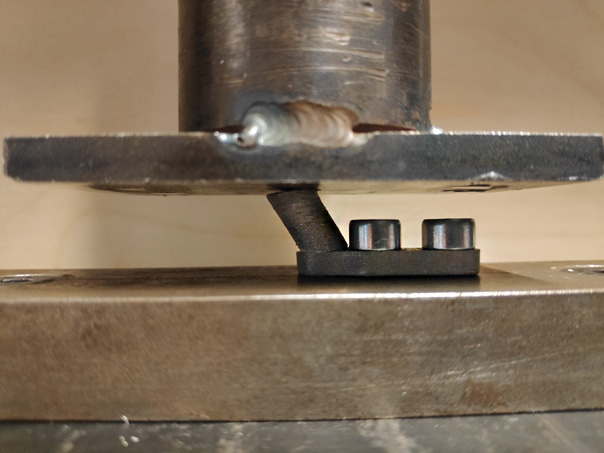 Close view of a custom printed pusher supporting a welded plate during testing